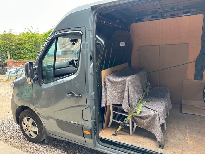 An antique chair being loaded and wrapped safely, so it is ready to leave for its new home
