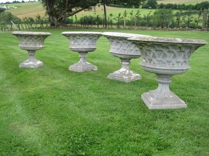 A set of 4 matching composition stone Austin and Seeley urns - 4139