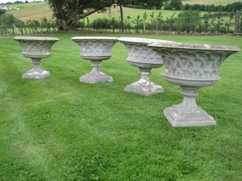 A set of 4 matching composition stone Austin and Seeley urns