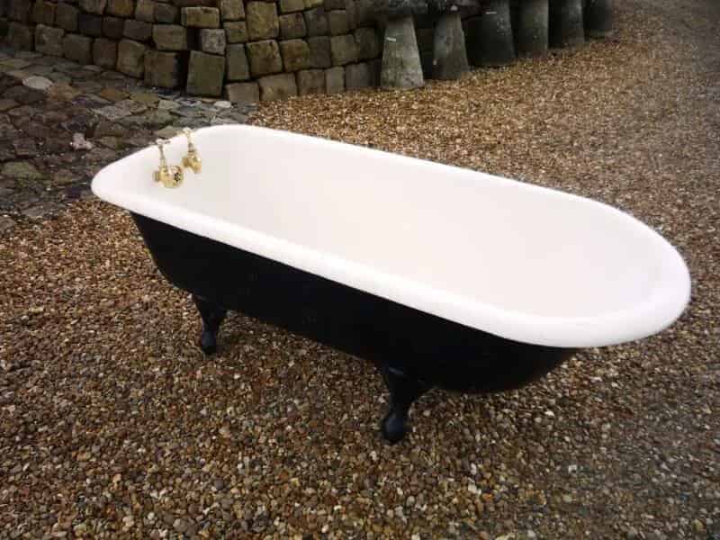 Reclaimed antique roll top cast iron bath with brass taps