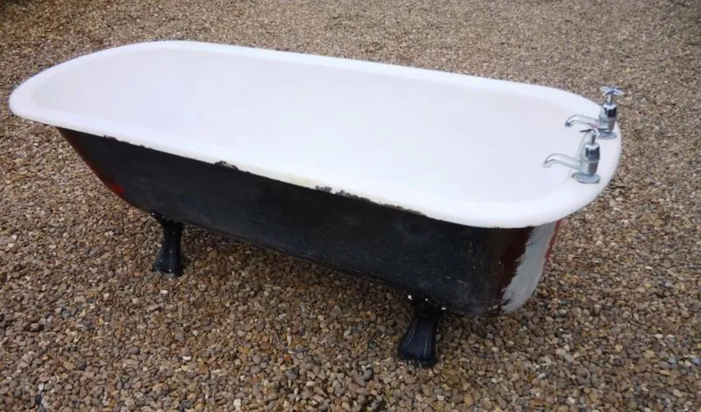 Salvaged antique roll top cast iron bath