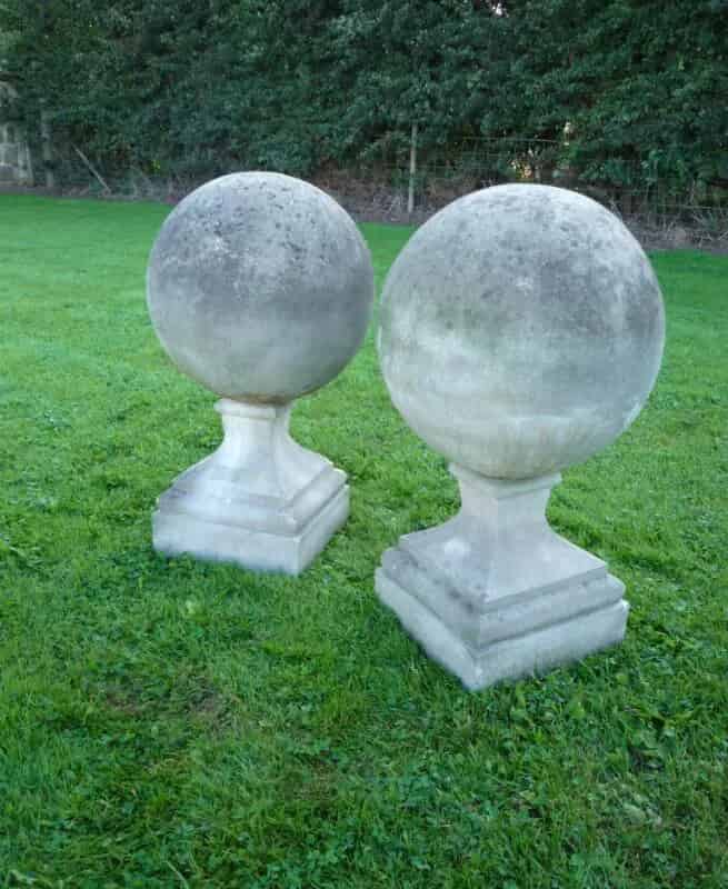A pair of composition stone gate pier ball finials
