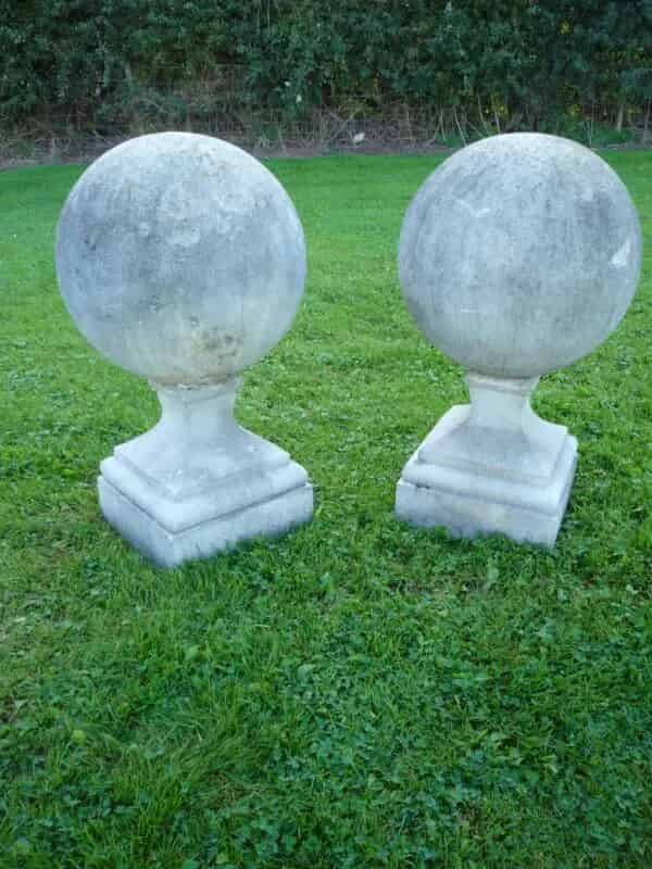 A pair of antique composition stone gate pier ball finials