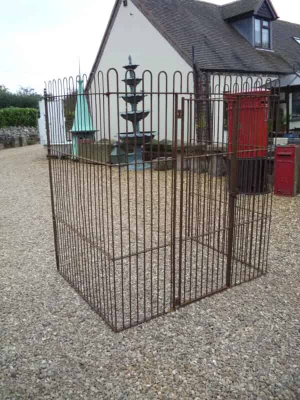An antique wrought iron dog kennel