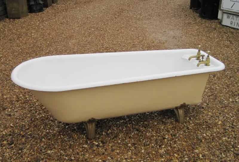 Salvaged antique roll top cast iron bath brass taps and waste