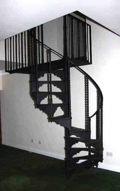 Reclaimed cast iron spiral staircase with a balcony