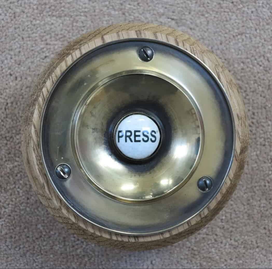 Antique Brass Door Bell Push Button on an Oak Plinth