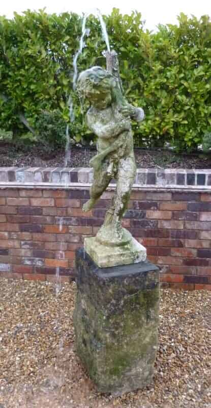 Reconstituted limestone fountain of boy with a fish